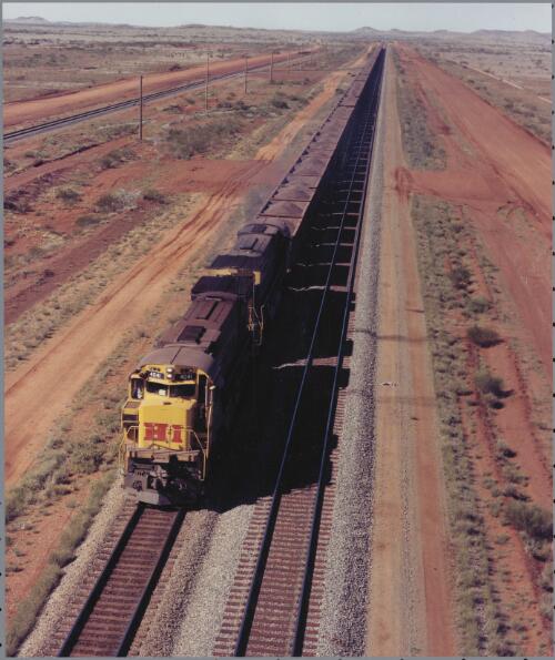 Hamersley Iron's train carrying iron ore from Mt. Tom Price in the Pilbara to Port Dampier in Western Australia, 1974 [picture] / Wolfgang Sievers