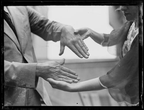 Boxer George Cook's hands being hand by a girl, New South Wales, February 1931 [picture]