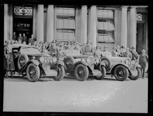 Motorists and crowds standing beside their Riley cars outside the Royal Automobile Club of Australia on their tour to London, New South Wales, 18 August 1931 [picture]