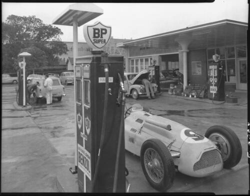 Unidentified men filling their car with petrol at Doug Whiteford service station, from BP and C.O.R. [i.e. Commonwealth Oil Refineries] bowser, 1957 [picture] / Wolfgang Sievers