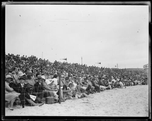 Large crowd behind barriers at Bondi Surf Carnival, Bondi Beach, New South Wales, ca. 1920s [picture]