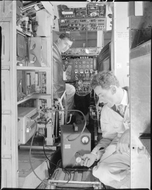 [Technicians checking equipment onboard an aircraft] [picture] / Wolfgang Sievers