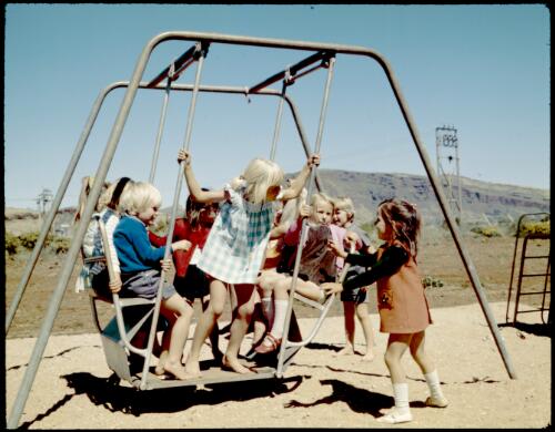 [Children on a swing at Tom Price, Western Australia, 1975 ] [transparency] / Wolfgang Sievers