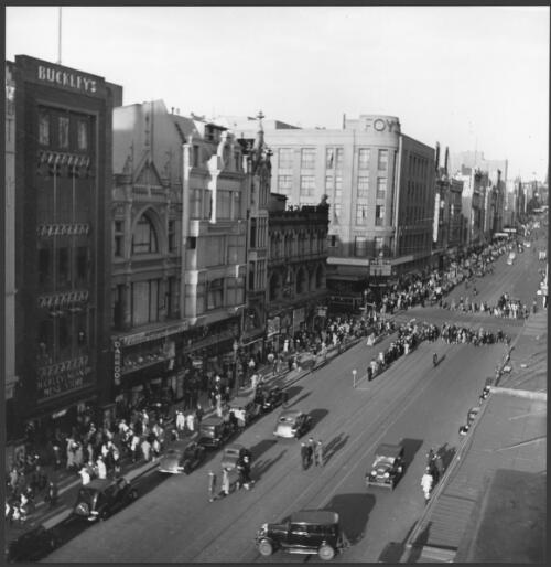 [View of] Bourke Street towards Parliament House, [with shopfronts including Buckleys, Darrods and Foys], Melbourne, 1939 [picture] / Wolfgang Sievers
