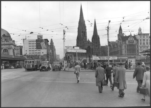Swanston Street Bridge [at street level], with Flinders Street Railway Station on left, St. Paul's in centre, Melbourne, Victoria, 1959 [picture] / Wolfgang Sievers