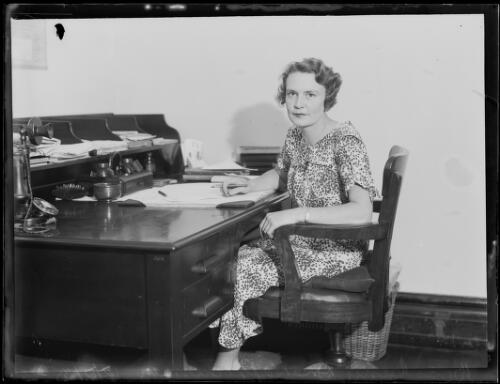 Judge's associate Miss Mary Drake Brockman seated at a desk at the Federal Arbitration Court, Sydney, 12 February 1935, 1 [picture]