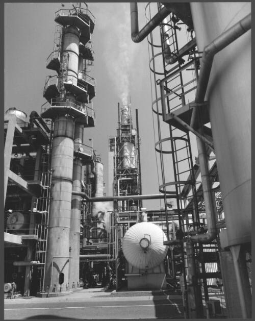 Plant pipelines and structures with smoking tower in the background at Mobil Refinery, Altona, Victoria, 1976 [picture] / Wolfgang Sievers