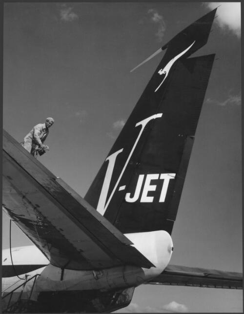 [Man on the tail of a] Qantas [Boeing 707 V-jet aircraft during] servicing, Mascot, New South Wales, 1961 [picture] / Wolfgang Sievers