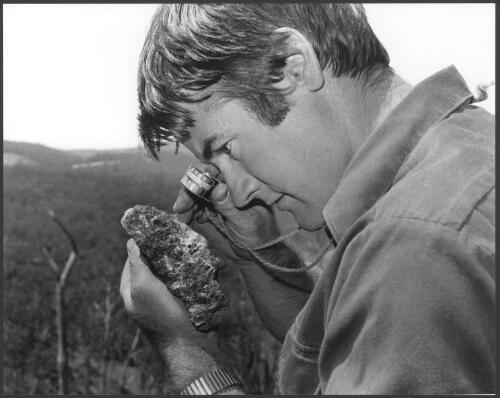Shell geologist, Ian Wilson, examining rock from an old mining area near Orange, New South Wales, 1980, 2 [picture] / Wolfgang Sievers