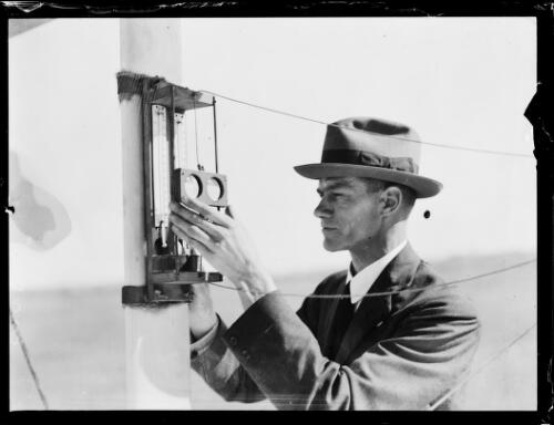 Meteorologist Edward Timckereading the temperature on thermometers at the Bureau of Meteorology, New South Wales, ca. 1920s [picture]