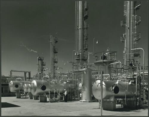 [Storage tanks with towers in the background at Mobil] Stanvac Oil Refinery, Altona, Victoria, 1956 [2] [picture] / Wolfgang Sievers