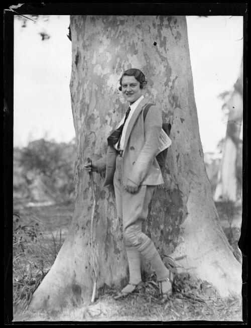 Woman hiker standing in front of a large gum tree, New South Wales, 1932 [picture]