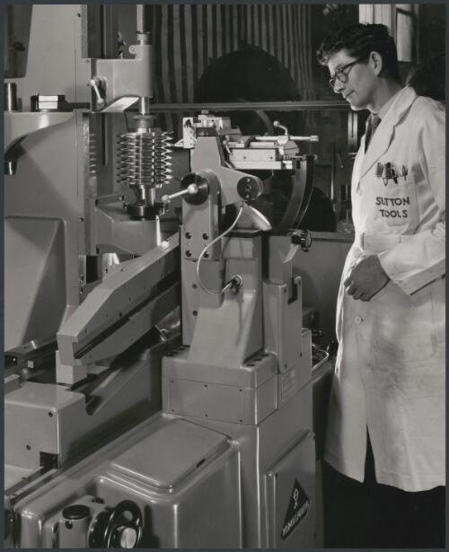 Sutton Tools employee attending metal lathe, Clifton Hill, Melbourne, 1960, 3 [picture] / Wolfgang Sievers