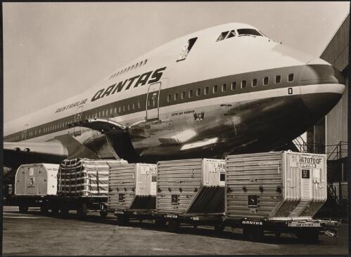Qantas air freight containers in front of a Qantas Boeing 747, Mascot Airport, Sydney, ca.1974 [picture] / Wolfgang Sievers