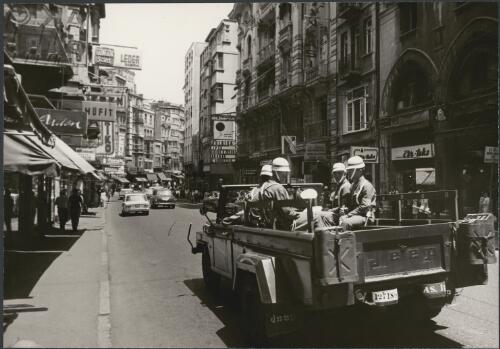 Soldiers in back of jeep travelling along Istanbul's main business street, Turkey 1966 [picture] / Wolfgang Sievers