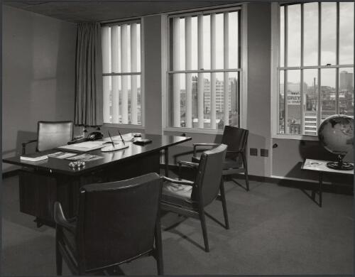 Office with desk, chairs and view of city from window, Electrolytic Zinc Company of Australasia, Melbourne, Victoria, 1959 [picture] / Wolfgang Sievers