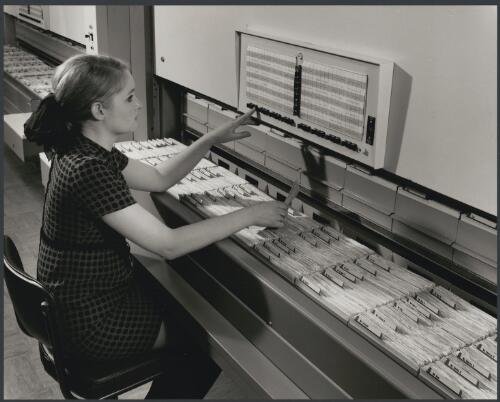 Employee using a file cabinet at Remington Rand, City road, South Melbourne, Victoria, 1968, 2 [picture] / Wolfgang Sievers