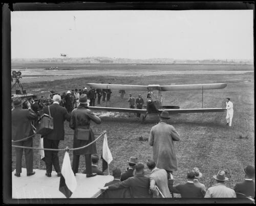 Sir Charles Kingsford Smith in his plane, the Southern Cross, arriving to a crowd, Mascot, New South Wales, 1930 [picture]