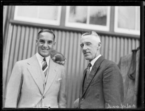 English cricketer Herbert Sutcliffe with an animal on his shoulder beside Mr Walsford [?], New South Wales, ca. 1930s [picture]