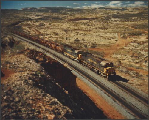 Hamersley Iron's train carrying iron ore from Mt. Tom Price in the Pilbara to Port Dampier in Western Australia, 1974, 2 [picture] / Wolfgang Sievers