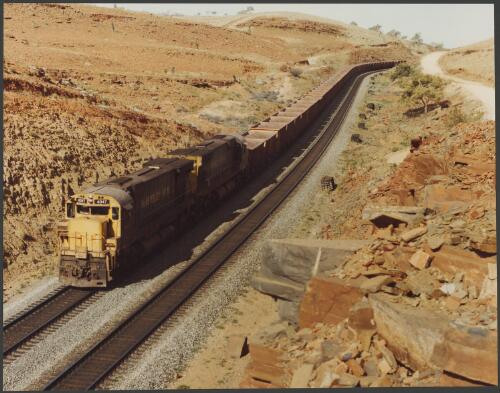 Hamersley Iron's train carrying iron ore from Mt. Tom Price in the Pilbara to Port Dampier in Western Australia, 1977, 3 [picture] / Wolfgang Sievers