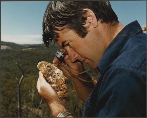 Shell geologist, Ian Wilson, examining rock from an old mining area near Orange, New South Wales, 1980, 3 [picture] / Wolfgang Sievers