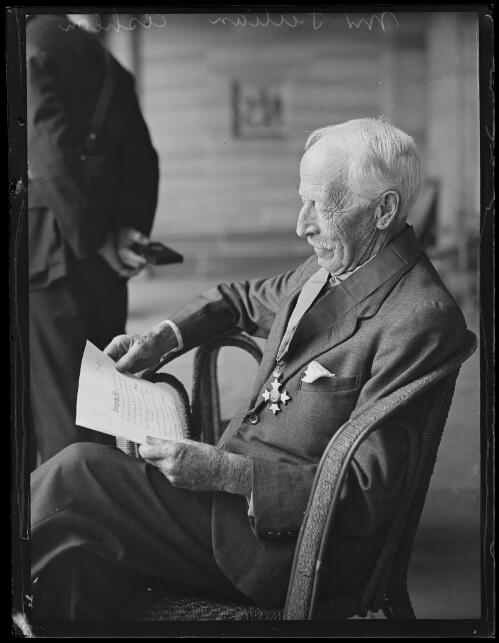 Julian Ashton reading whilst sitting in the Queen Victoria Building, Sydney, 24 August 1929 [picture]