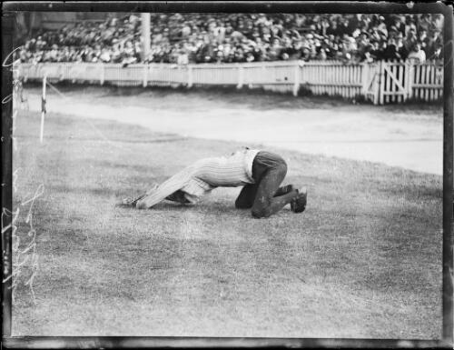 Escapologist Mr Norman Murray Walters removing a straight jacket in front of a crowd, New South Wales, ca. 1930, 1 [picture]