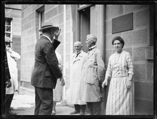 Sir Edgar Bertram MacKennal standing outside building with a group of people, New South Wales, ca. 1926 [picture]