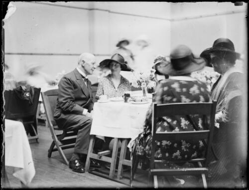 Sir Edgar Bertram Mackennal and wife Lady Annabella Bertram Mackennal sitting at a table with others, New South Wales, ca. 1926, 2 [picture]
