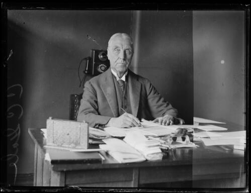 Solicitor Mr C.C. Gale sitting at an office desk, New South Wales, 27 July 1928, 2 [picture]
