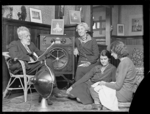 Family in their living room listening to a radio broadcast, New South Wales, ca. 1930 [picture]