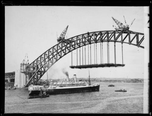Orient Steam Navigation Company ocean liner RMS Otranto passing under the partially constructed Sydney Harbour Bridge, Sydney, ca. 1930 [picture]