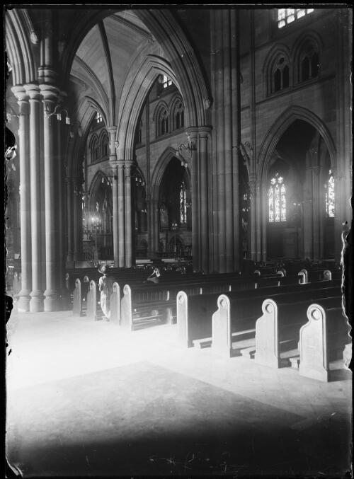 Two people praying in the pews of St. Mary's Cathedral, Sydney, ca. 1930 [picture]