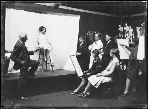 Artist Julian Ashton conducting a figure drawing class alongside a model, Sydney, August, 1927 [picture]