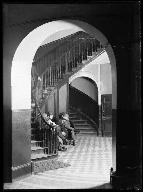 Men waiting under the staircase in the Supreme Court, Sydney, ca. 1930s [picture]