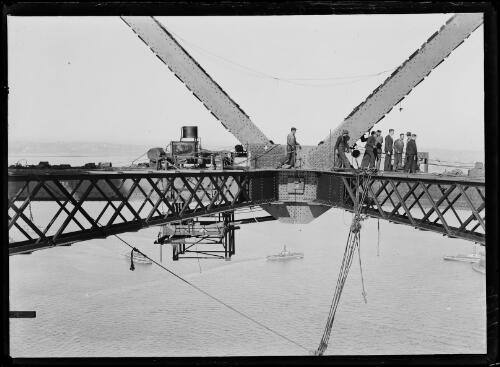Men standing on a metal girdle during the construction of the Sydney Harbour Bridge, Sydney, 1926 [picture]