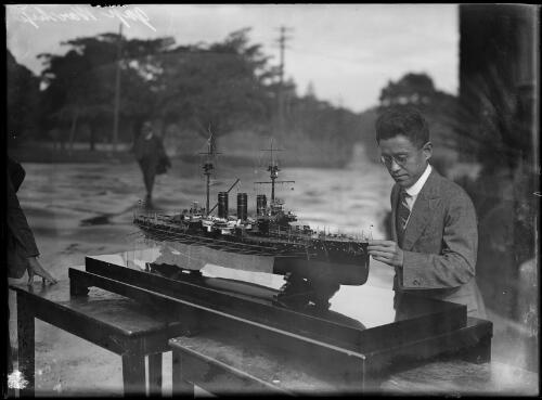 Man examining a model of a Japanese warship, New South Wales, ca. 1920s [picture]