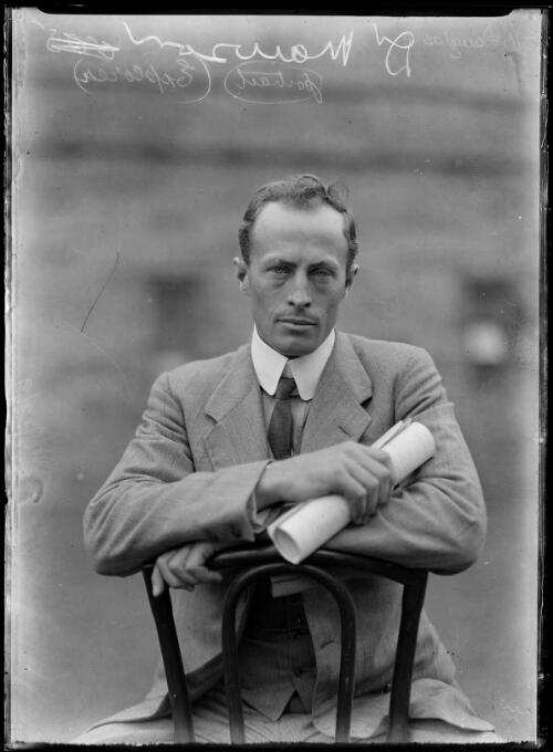 Sir Douglas Mawson sitting on a chair holding a document, New South Wales, ca. 1914 [picture]