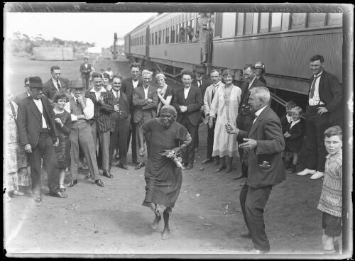 Aboriginal woman dancing in front of a group of passengers on the Trans Australia Railway, South Australia, 1924 [picture]