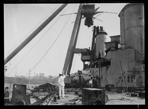 HMAS Australia at Garden Island Dockyard with the sheerlegs crane removing the tripod mast prior to scuttling, New South Wales, ca. 1924 [picture]