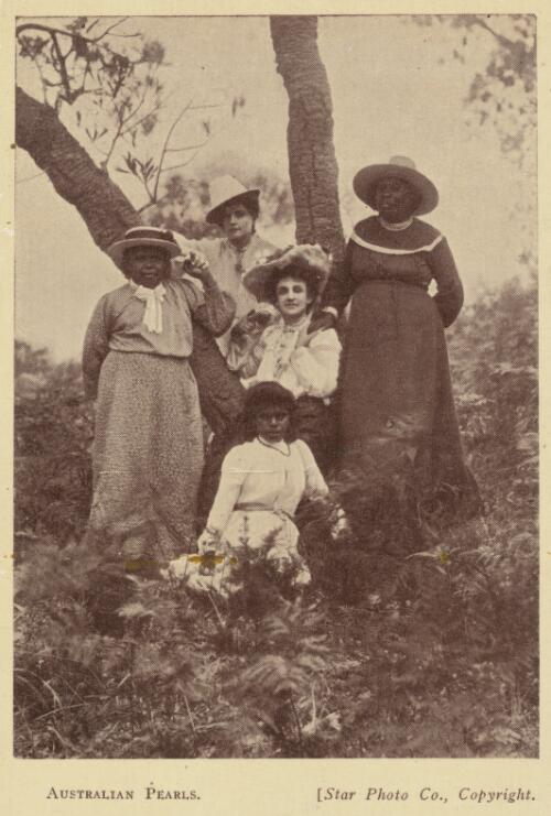 Group of five women posing against a tree, approximately 1910 / Star Photo Co