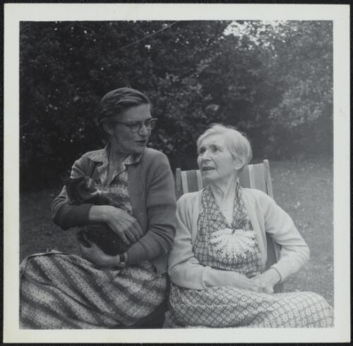 Nettie Palmer seated with Aileen Palmer holding the cat Pushkin, Ardmore, Kew, Victoria, 1964