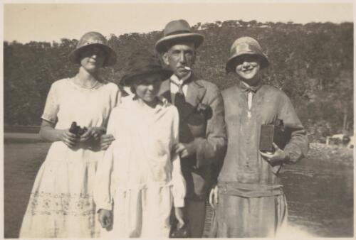 Billy Hughes with family members (?) standing by a river. [picture]