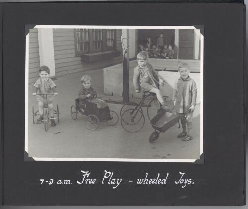 [Photograph of children playing with wheeled toys during free play  at] 7-9 a.m [picture]