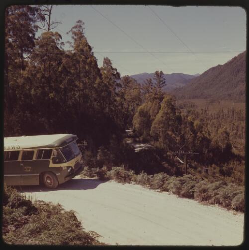 Bus travelling around a bend on the Lyell Highway, Queenstown, Tasmania, 1963 / Michael Terry