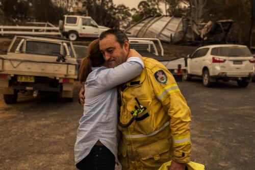 Jenny Morrison wife of Prime Minister Scott Morrison, embracing Mark Ayliffe Captain of the Cobargo Rural Fire Service Brigade, Cobargo, New South Wales, 2 January  2020 / Sean Davey