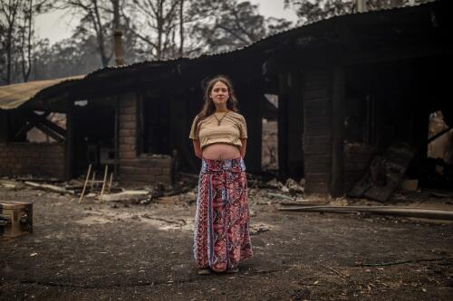 Zoey Salucci-McDermott in front of her fire damaged home destroyed by the bushfires, Cobargo, New South Wales, 3 January 2020 / Sean Davey