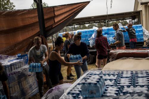 Volunteers unloading donated water from a truck at the Cobargo Community Bushfire Relief Centre, Cobargo, New South Wales, 9 January 2020 / Sean Davey