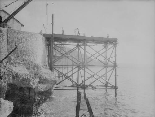 Workmen and crane during the construction of Christmas Island Phosphate Company pier, Christmas Island, approximately 1902, 4